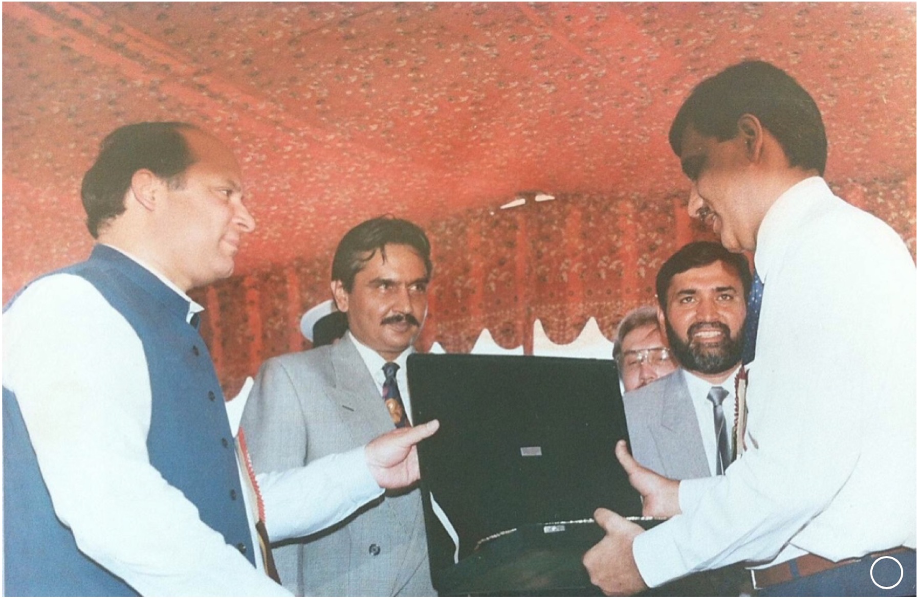 Prime Minister Nawaz Sharif presents an award for establishing the pioneer seed plant in Sahiwal.